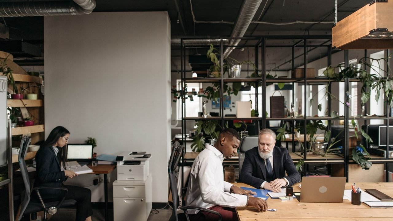 Diverse team engaged in a meeting in a modern open office environment.